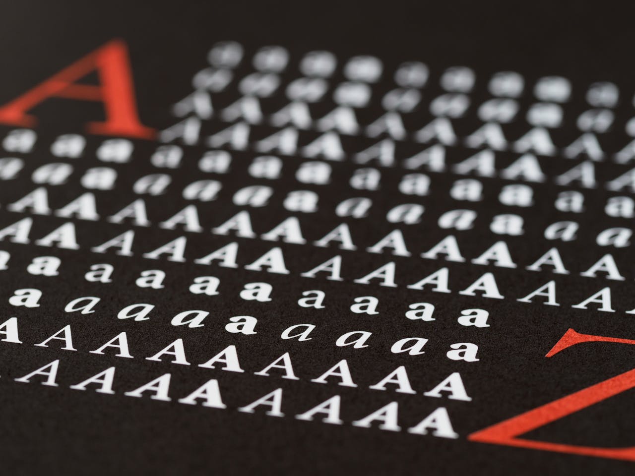 services-02 Close-up image showcasing various styles of the letter A in print, emphasizing typography diversity.