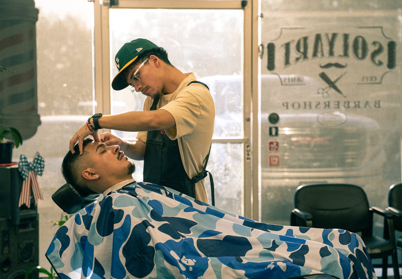 services-01 Barber giving a precise haircut to a client at a shop in Redlands, CA. Capturing the essence of personal grooming.