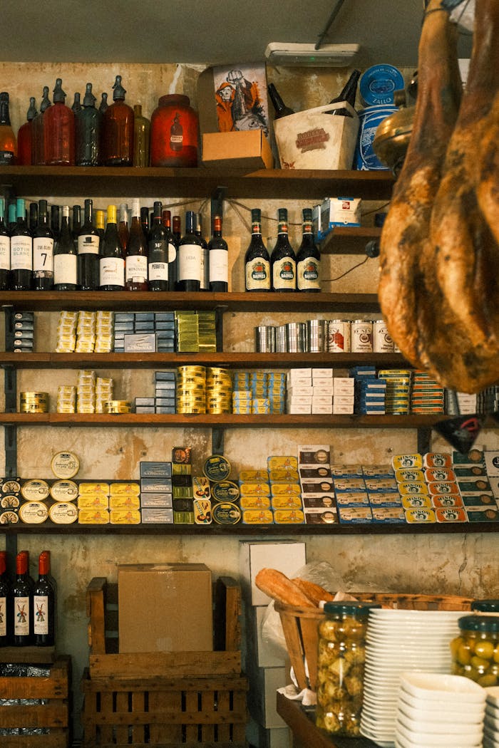 A cozy grocery store in Barcelona with wines, canned goods, and rustic decor.